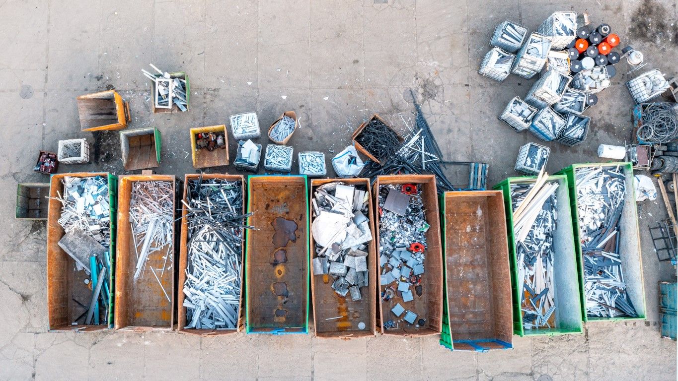 Aerial view of sorted scrap metal and recyclable material staged for disposal